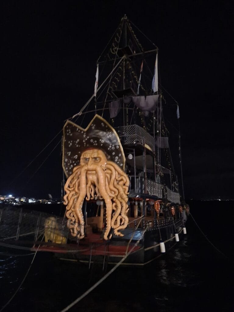 Illuminated pirate ship at night in Sarandë, Albania