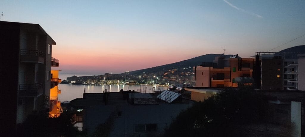 Twilight view of Sarandë, Albania with warm lights and coastal scenery