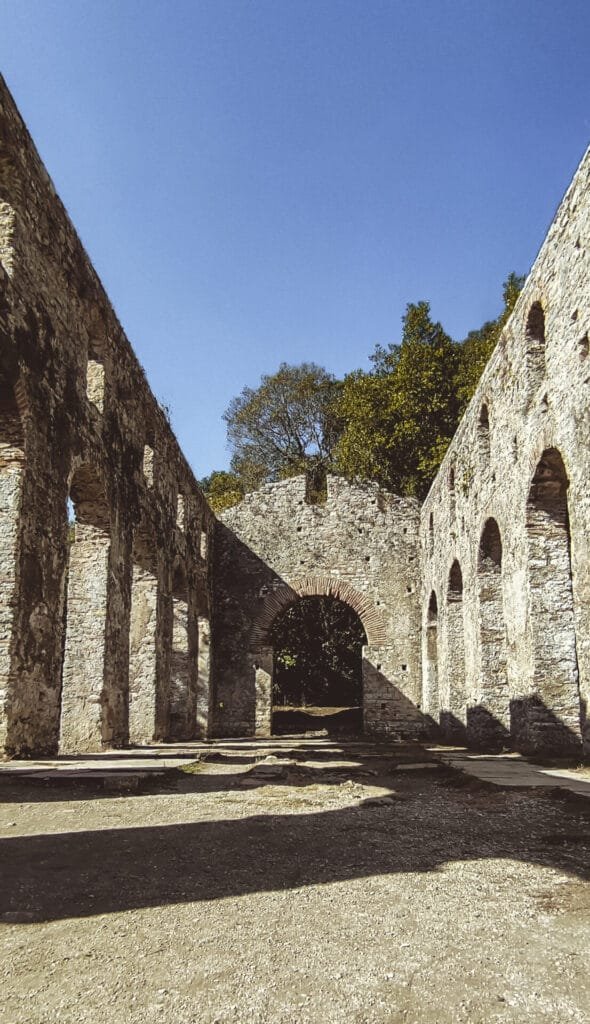 Interior view of Butrint's Basilica, featuring intricate mosaic floors and architectural remains