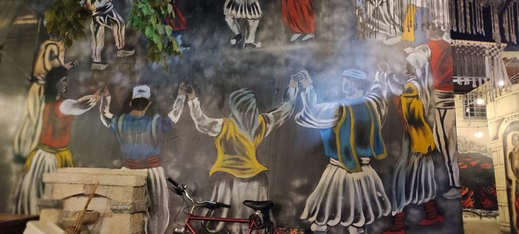 Colorful mural with people dancing in traditional attire