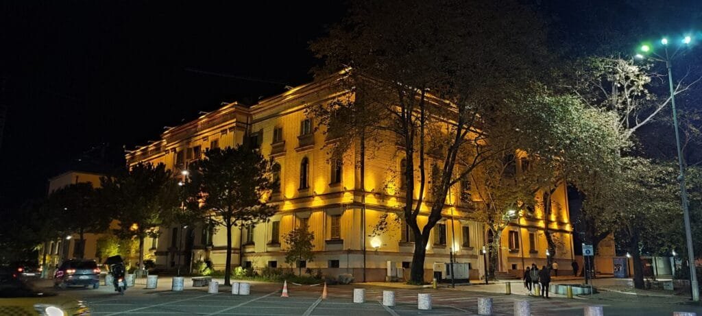 Illuminated building at night with trees