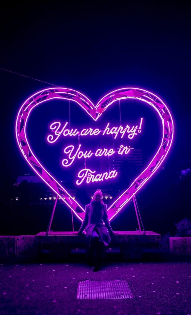 Neon heart sign with message "You are happy! You are in Tirana!"