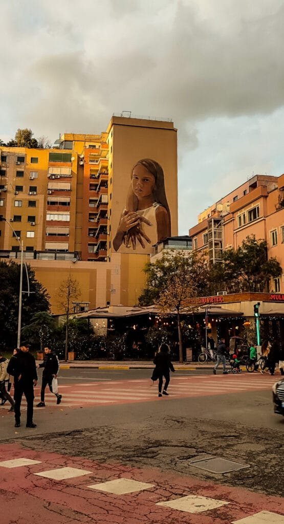 Large mural on building facade in urban area