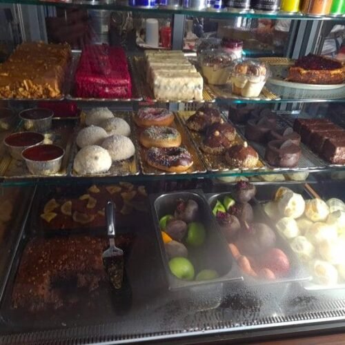 Display of traditional Albanian pastries in a glass case